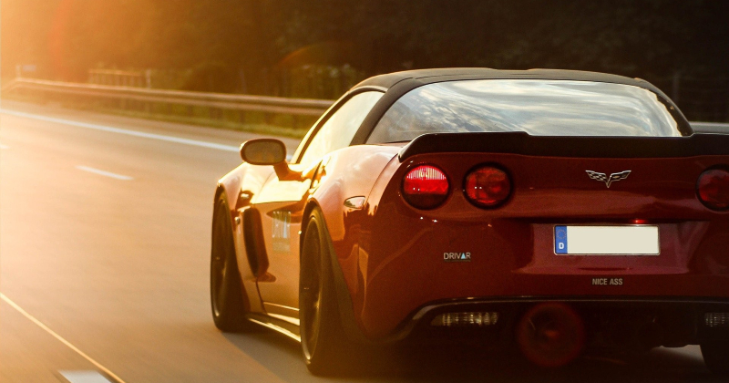 Corvette car driving on open road.