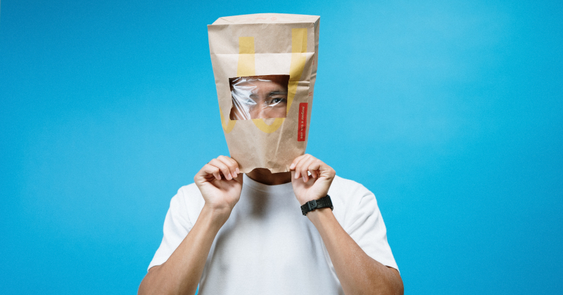 Man with bag over his head.