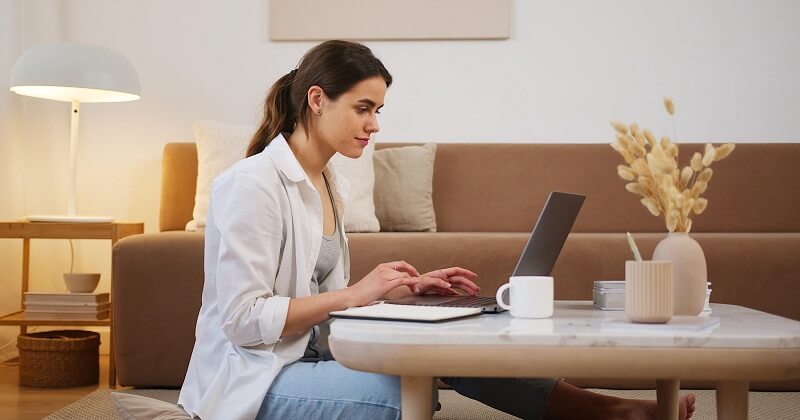 Woman creating SEO content on laptop.