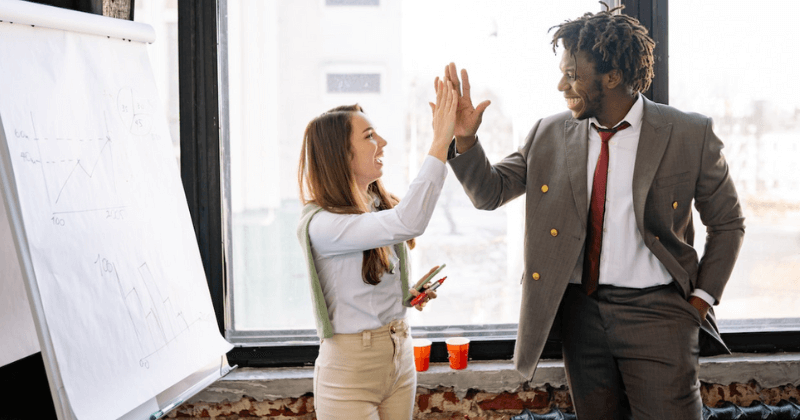 Two colleagues high-fiving